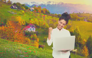 developer with laptop, hillside in the background