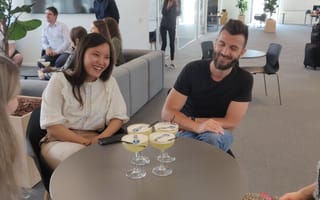 Four members of the project44 team sit around a table enjoying happy hour drinks together