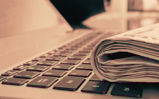 newspaper on laptop