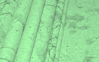 A green-toned image of road maps. /customer-success/solutions-roadmap