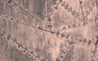 An orange-toned image of irregular cuts of metal bolted together. /design-ux/scrappy-ux-research