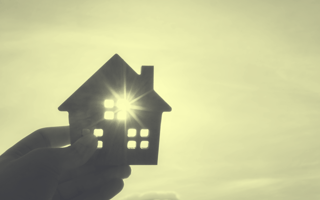 A yellow-toned image of a cutout of a home being held in front of the sun. /founders-entrepreneurship/startup-hq-actually-want-to-live