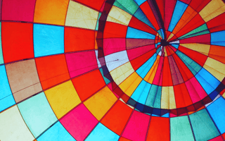 The multicolored patches of a hot air ballon fit perfectly to help propel the ballon higher.