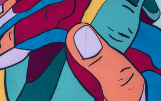 A corporate charitable hand embracing the hand of its community and lifting each other up.