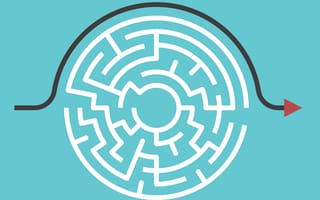 Illustration of a circular maze with an arrow solving the puzzle by instead following around the outer edge of the maze