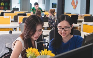 two teammates at computer