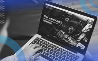 recommendation-engines blurry person in the foreground surfing Netflix on a laptop