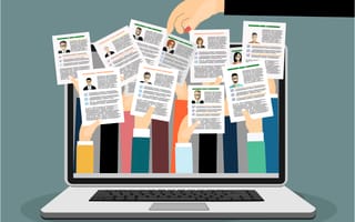 A laptop with several hands holding resumes sticking out of it. A hand with painted nails reaches above the laptop, selecting a resume.