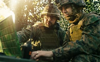 Members of the military using tech in the field.