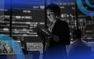 A woman uses a tablet in a data-filled command center for a public transit system. /big-data/top-roles-responsibilities-salaries