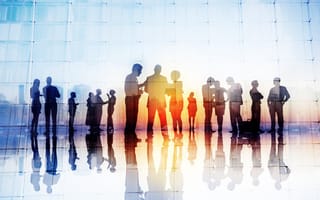 A silhouette of tech employees making big plans.