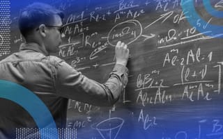 A physicist works on a problem on a chalkboard filled with equations