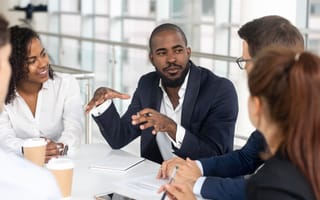 A group of employees holding a sales meeting.