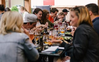 A group of coworkers enjoying a meal at a restaurant together.
