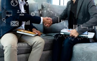 business partners shaking hands with digital layer of business strategy and social media diagram
