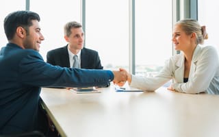 Business people shaking hands after finishing up a meeting