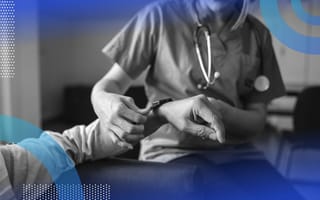 A doctor places a smartwatch on a patient's wrist. /healthcare-technology/IoT-better-care-cybersecurity