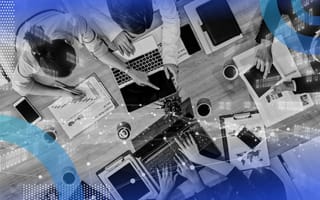 An aerial view of several people working on laptops