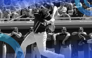 A baseball player swings during an at-bat