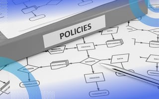 A binder labeled "policies" sits on top of a process flowchart. /corporate-innovation/3-compliance-trends-2022