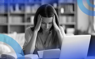 A woman looks at a computer in frustration.