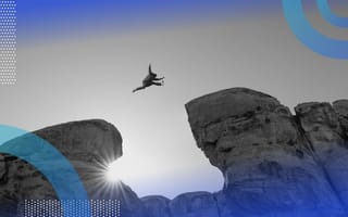 An adventurer jumps from one rock outcropping to another