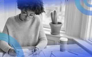 t-test-vs-chi-square woman at a desk with a coffee marking papers with graphs on them