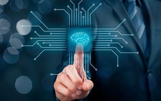 A businessman pressing a a microchip with an illustration of a brain on it