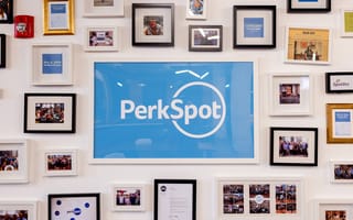 Framed PerkSpot logo on a wall of framed pictures in the PerkSpot Office