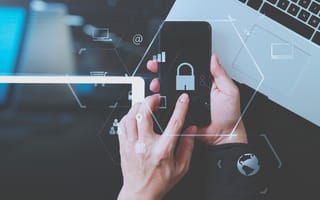 Businessman hand working with VR screen padlock icon mobile phone on laptop computer and digital tablet