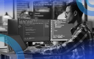 person coding on a desktop computer