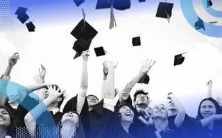 A group of graduates throw their mortarboards into the air