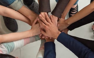 Close up of a group of people doing a team hand stack