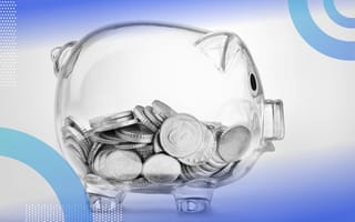 How Your Company Can Achieve Pay Equity and Transparency A glass piggybank filled with coins