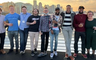 Reggora team photo outside with skyline in the background