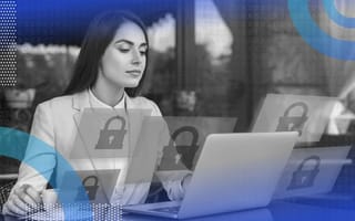 A woman works at a laptop with floating locks around her