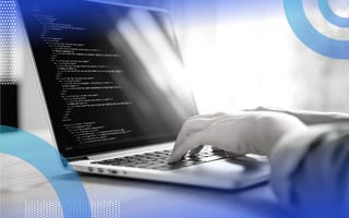 person writing code on a laptop