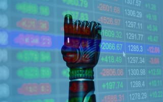 robotic hand in front of stock exchange