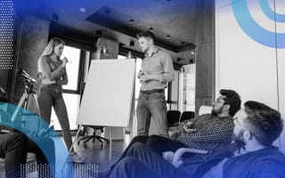 A team has a meeting around a whiteboard
