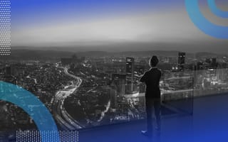 A person looks out on the city from a high vantage point