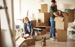 two people pack up their belongings to move house