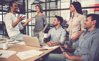 groups of coworkers around a table talking
