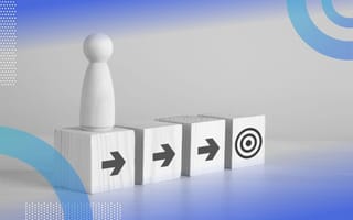 Four wooden blocks are in a row. A pawn sits on top of the first one. The first three have right-facing arrows. The fourth has a bullseye. /founders-entrepreneurship/turn-goals-into-actions-procopio