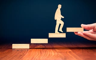 a wooden figure walking up steps