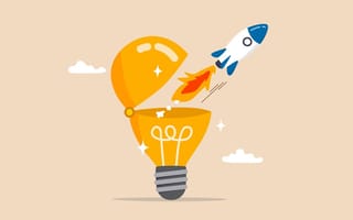An illustration of a rocket launching out of bright lightbulb