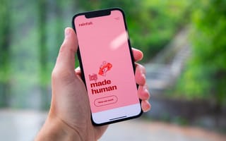 Person holding a mobile phone with the Rainfall app on the screen