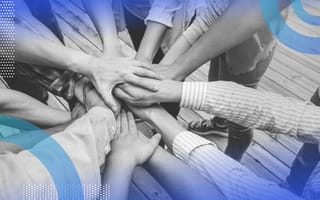 A group of people put their hands into a pile
