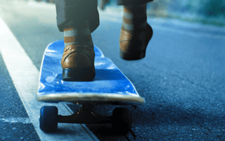 person in suit on skateboard
