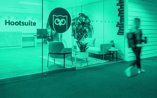 Hootsuite's office redesign with their logo on a glass wall.