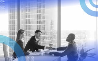 A job candidate shakes hands with two interviewers